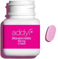 Open Addyi bottle with a pill next to it