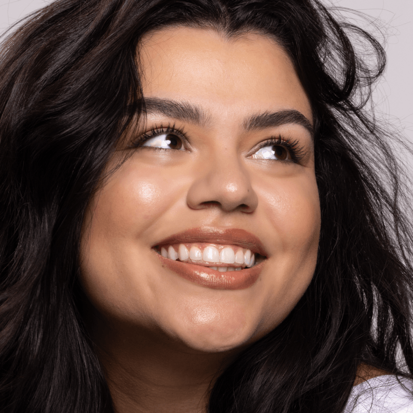 Young woman smiling, representing the 21 to 28 age range for preventative Botox treatments